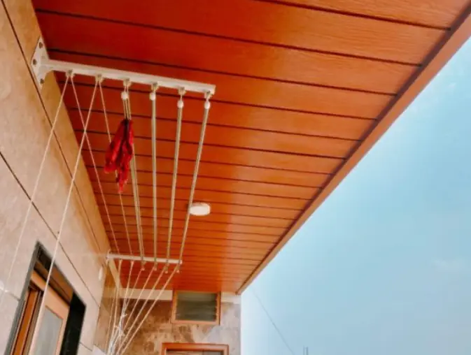 Stainless steel ceiling cloth drying hanger fitted on a Chennai balcony
